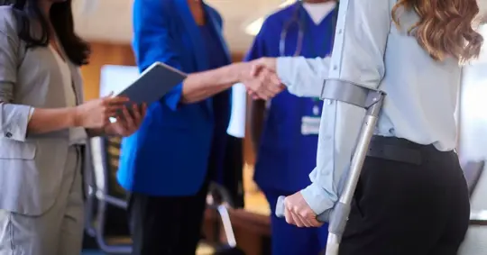 injured woman talking to doctors and a lawyer